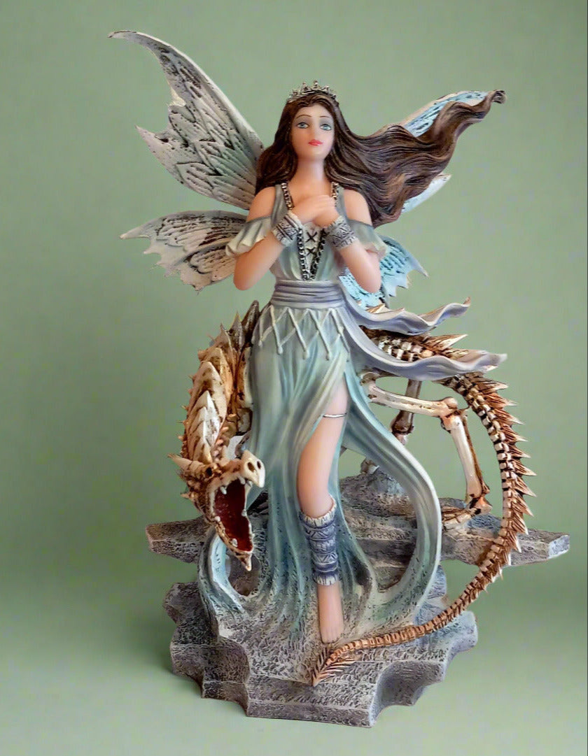A blue fairy with the skeleton of a dragon wrapped round the fairy